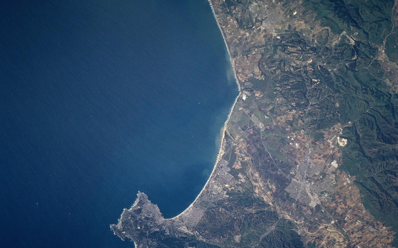 Satellite photograph of Monterey Bay taken from the Space Shuttle showing the curved coastline and peninsula formation